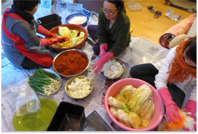 Family members making kimchi